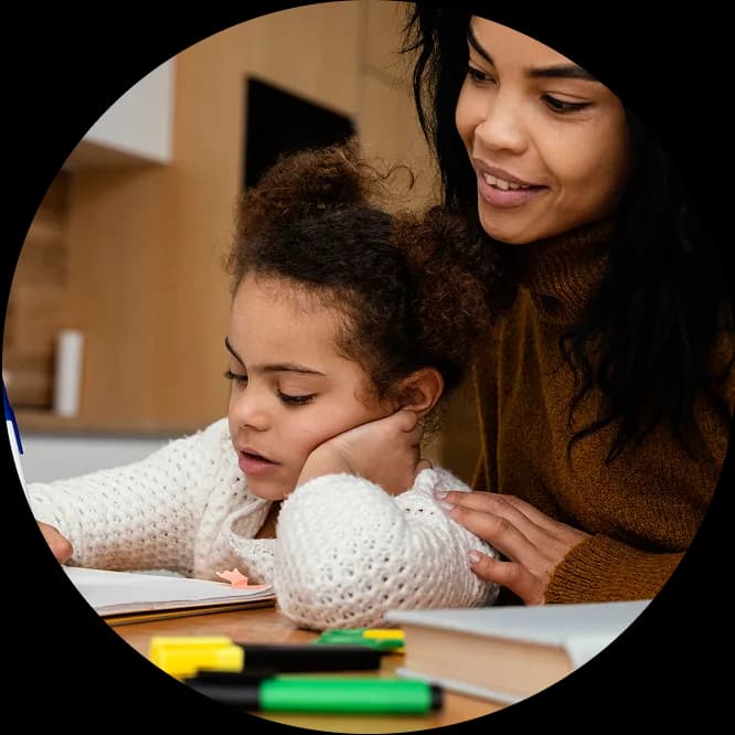 A learner reading and taking notes at home.